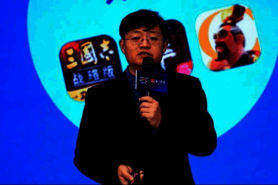 唐贾军在论坛上发表演讲,身后大屏幕展示《2024中国游戏产业未成年人保护报告》核心数据图表